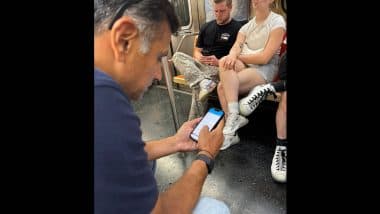 Team India Head Coach Rahul Dravid Spotted Following T20 World Cup 2024 Live Score Updates on Mobile in New York Subway During PAK vs USA Super Over, Pic Goes Viral