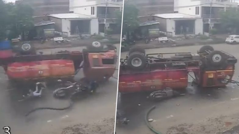 Accident Caught on Camera in Gujarat: Narrow Escape for Scooter Rider as Fire Brigade Truck Overturns in Vadodara, Video Surfaces