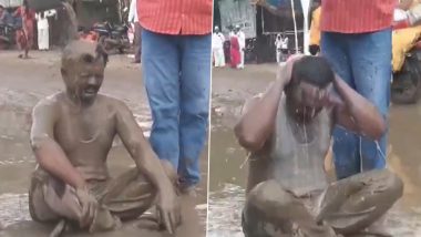 Shevgaon: CPI Leader Sanjay Nangre Sits in Pothole in Ahmednagar, Pours Dirty Water on Himself To Protest Against Administration Over Waterlogging Issue; Video Surfaces