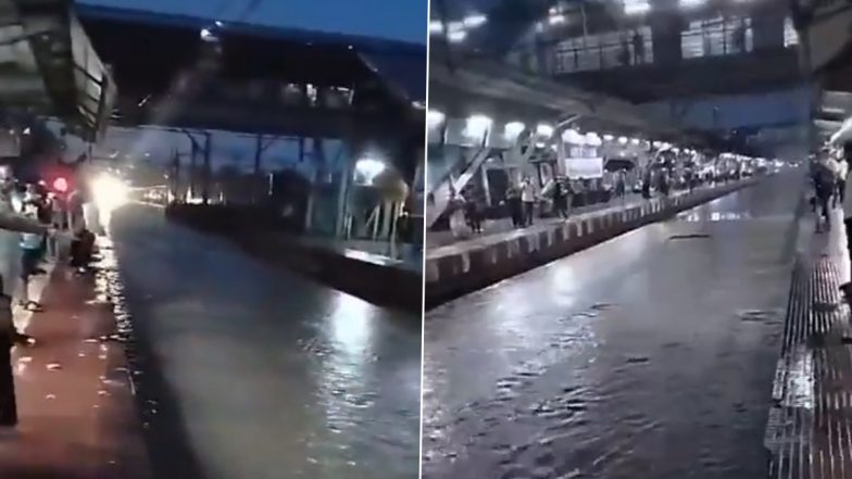 Mumbai Rains: Local Train Services Disrupted As Kurla Railway Station Track Gets Waterlogged Due to Heavy Rainfall, Commuters Seen Walking on LBS Road (Watch Videos)