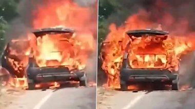 Bahraich: Car Catches Fire on National Highway Near Girgitty Village; Family Escapes Unharmed as Police Move Vehicle to Safety (Watch Video)