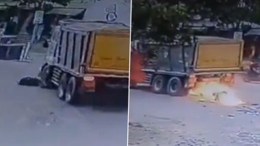 Telangana Road Accident: Bike Catches Fire After Being Run Over by Tipper Lorry in Medak, 1 Injured; CCTV Footage Surfaces