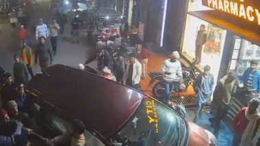 Amroha Car Crash: Drunk Driver Runs Over Biker, Crashes Vehicle at Entrance of Pharmacy; Locals Thrash Him (Watch Video)