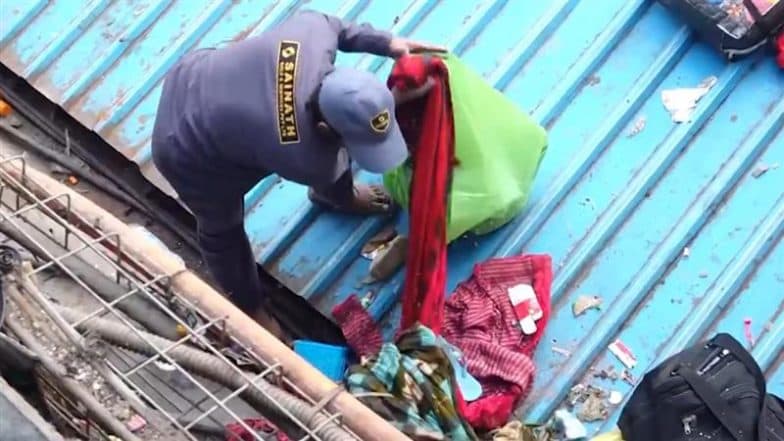 New Delhi Railway Station Stampede: Indian Railway Staff Seen Cleaning Passengers’ Belongings From Platform Roof, Video Surfaces