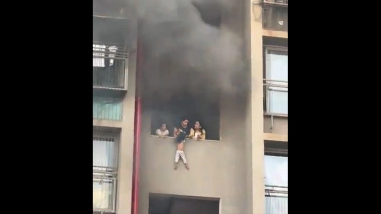 Ahmedabad Fire: Heart-Stopping Videos Show Woman and 2 Kids Clinging to Wall of Burning Building in Desperate Wait for Rescue, Man Descending Balcony To Escape Flames