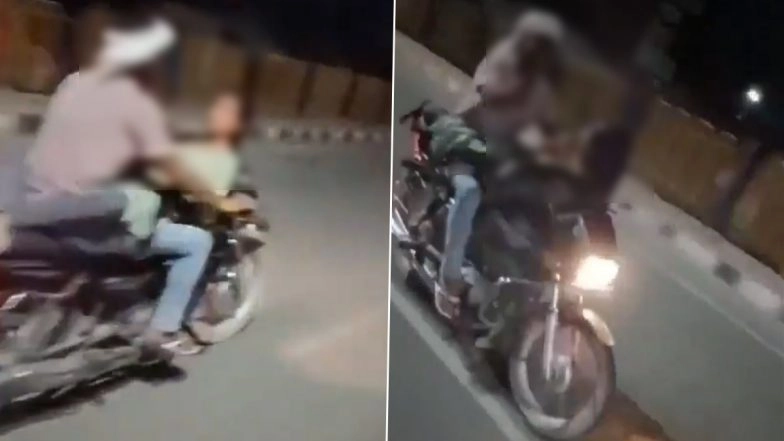 Firozabad Couple Romance Viral Video: Woman Seen Lying on Fuel Tank as Man Rides Bike Without Helmet on Agra-Kanpur National Highway in Uttar Pradesh