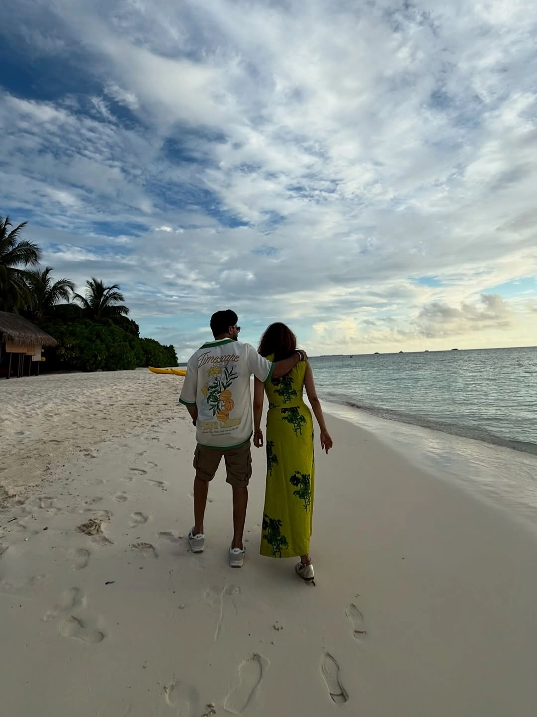 Captured during a tranquil sunset stroll, their silhouettes holding hands along the shoreline speak volumes of their bond.