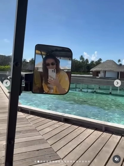 A dreamy snapshot of the duo by the overwater cottages, with turquoise sea all around—a perfect Maldives postcard moment.