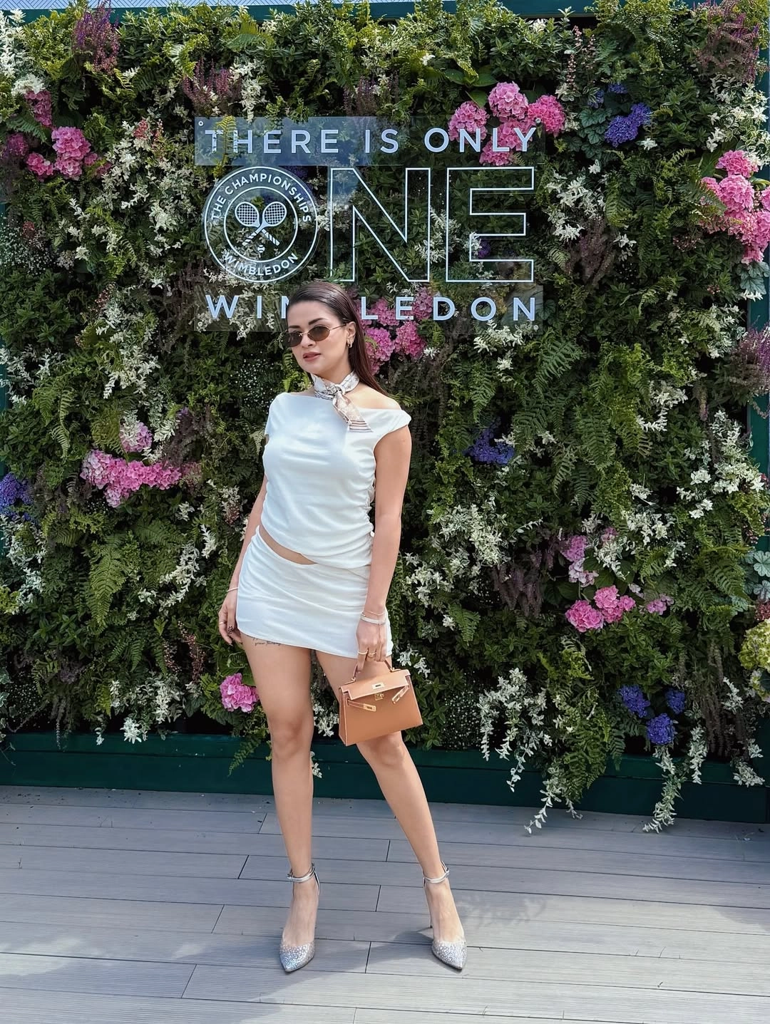 She styled her look with metallic heels and crystal accents, adding glamour to the courtside.