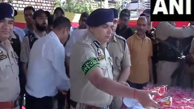 India News | Srinagar: Senior Police Officials Distribute Water Among Shia Mourners Participating in Muharram Procession