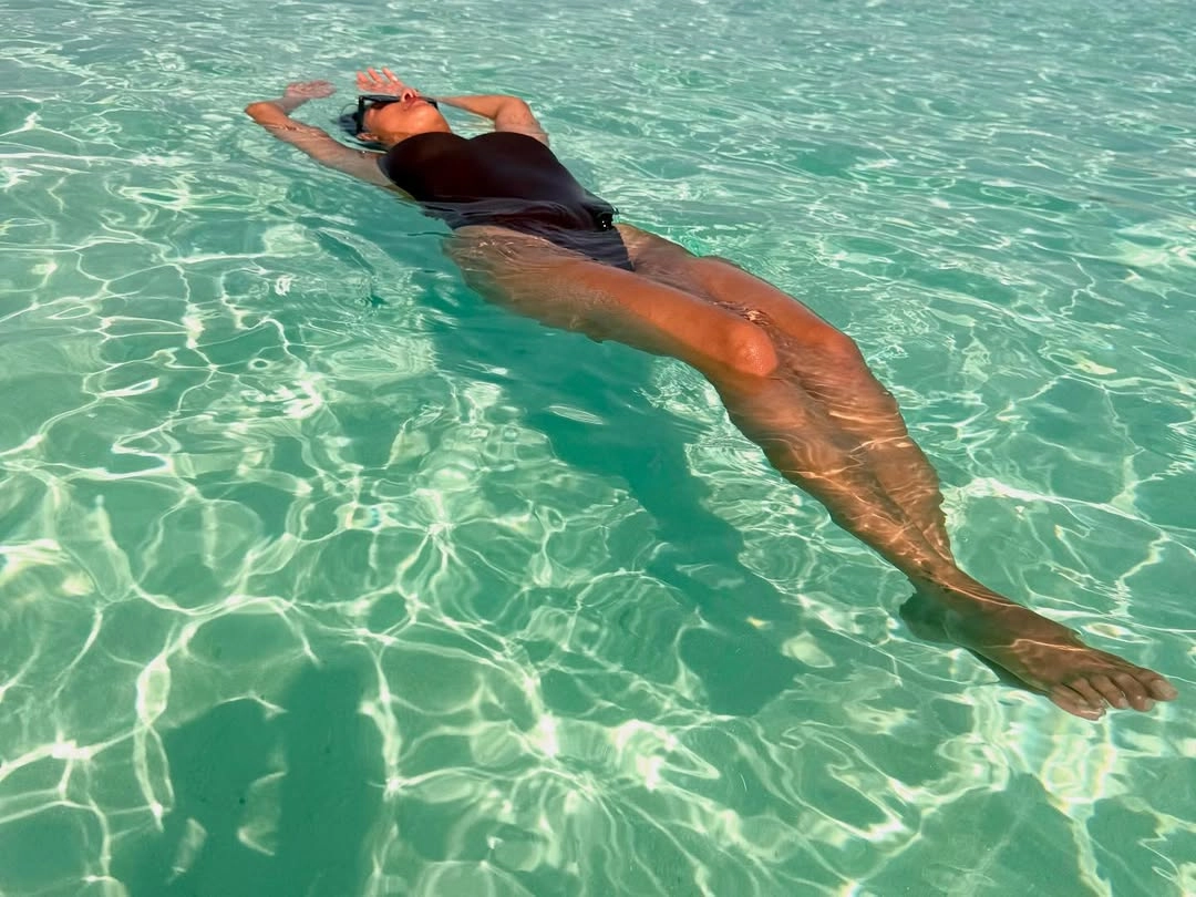 The classic black monokini showcases her curves and adds a touch of sophisticated allure.