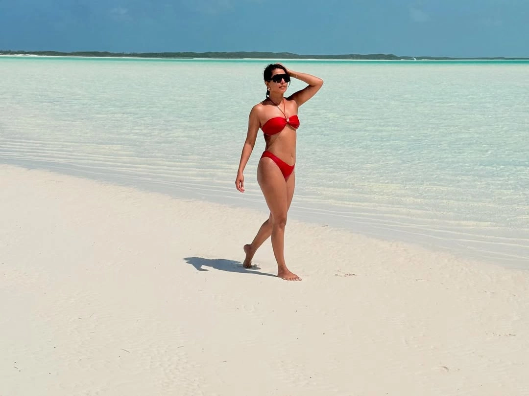 Chopra flaunts a chic red two-piece that enhances her sun-kissed glow.
