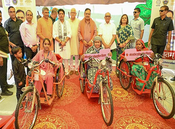 India News | Rajasthan CM Bhajanlal Sharma Distributes Motorised Tricycles to Specially-abled Girls, Women in Jamdoli