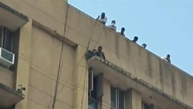 Delhi: Man Sits on Edge of Sanjay Gandhi Hospital Roof in Mangolpuri, Rescue Operation Underway (Watch Video)
