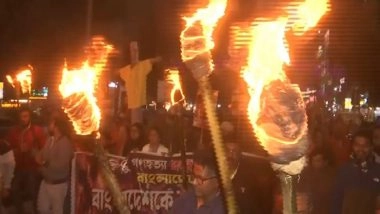 India News | West Bengal: BJP Workers Hold Torchlight Rally in Siliguri Against Atrocities on Hindus in Bangladesh