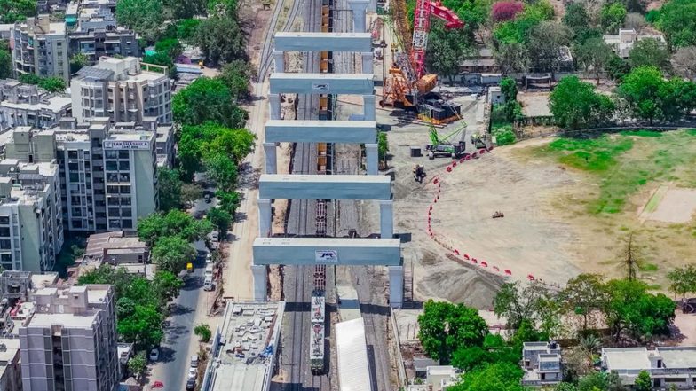 Business News | Mumbai-Ahmedabad Bullet Train Project Installs Five Heavy Portal Beams over Ahmedabad Tracks in 22 Days