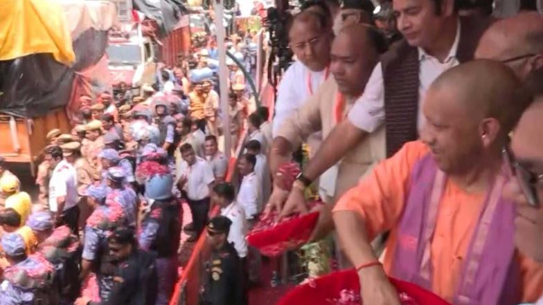 India News | Uttar Pradesh CM Yogi Showers Flowers on Kanwariyas in Meerut, Says 4-4.5 Crore Devotees Expected