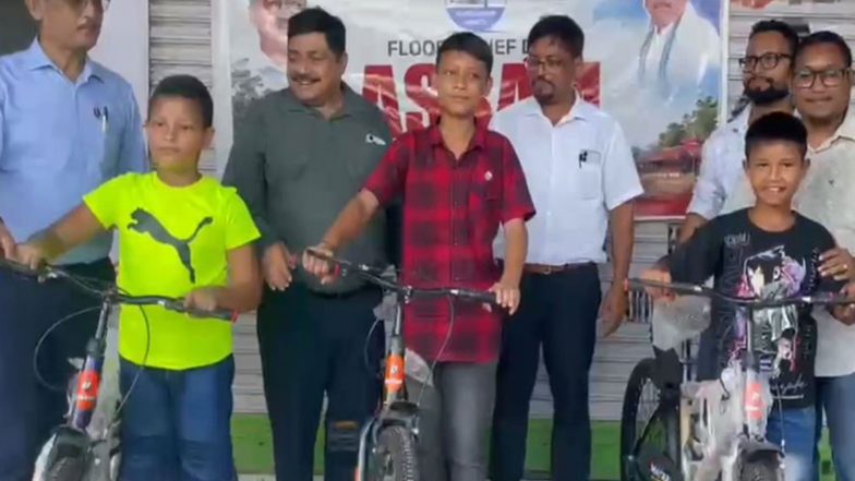 India News | Assam: AAP's Sanjay Singh Provides Bicycles to Flood-hit Students, Computers to Schools in Sivasagar