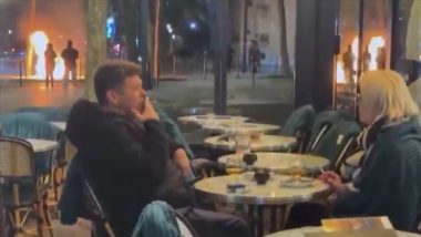 Viral Video Shows Couple Calmly Sipping Drinks at France Cafe Amid Raging Street Protests and Fires